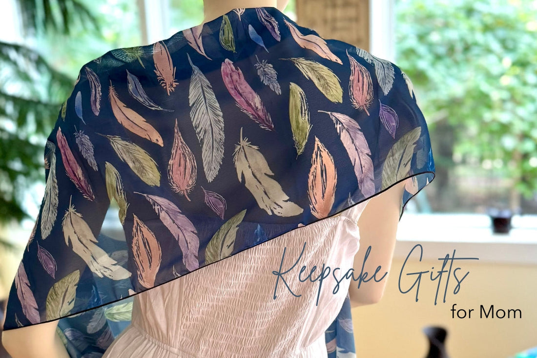 deep navy pattern with colorful feathers on a shawl draped over shoulders