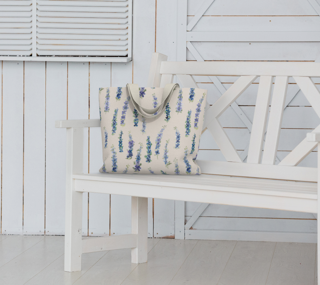 Weekender Tote with Dancing Delphinium on Cream pattern on a bench